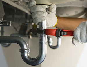 Plumber fixing sink pipe